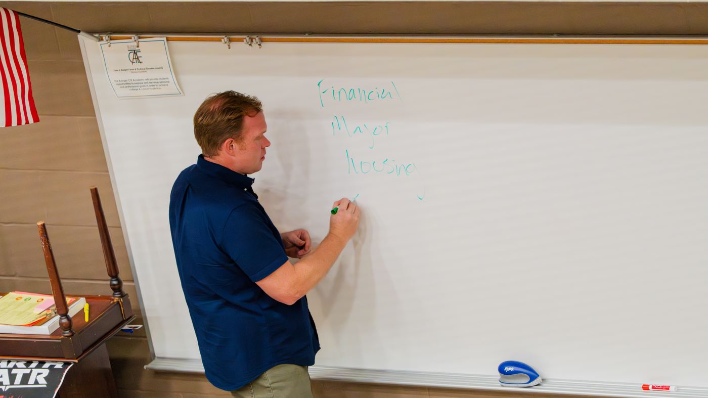 Ben Roberts writing on a whiteboard during a class session